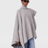 Asymmetrisk poncho med hög hals i stickat